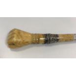 A Victorian carved ivory and bone conductor's baton, the handle as a clenched fist with embossed