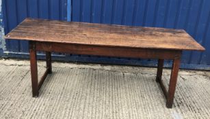 A 19th Century oak refectory style dining table, the four plank top above a plain frieze, raised