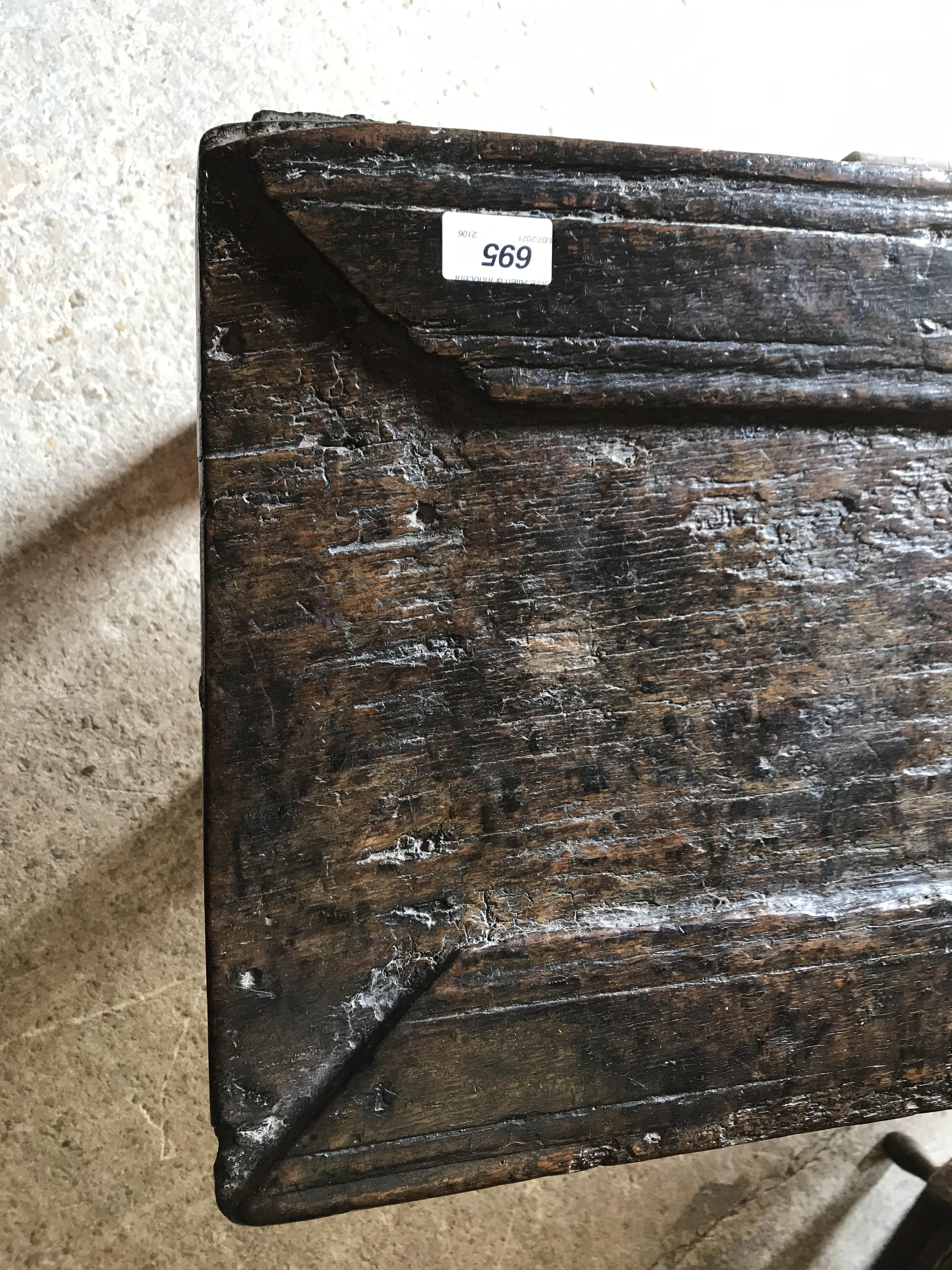 An 18th Century oak coffer, the single piece carved plank top over a three panel front with - Image 2 of 24