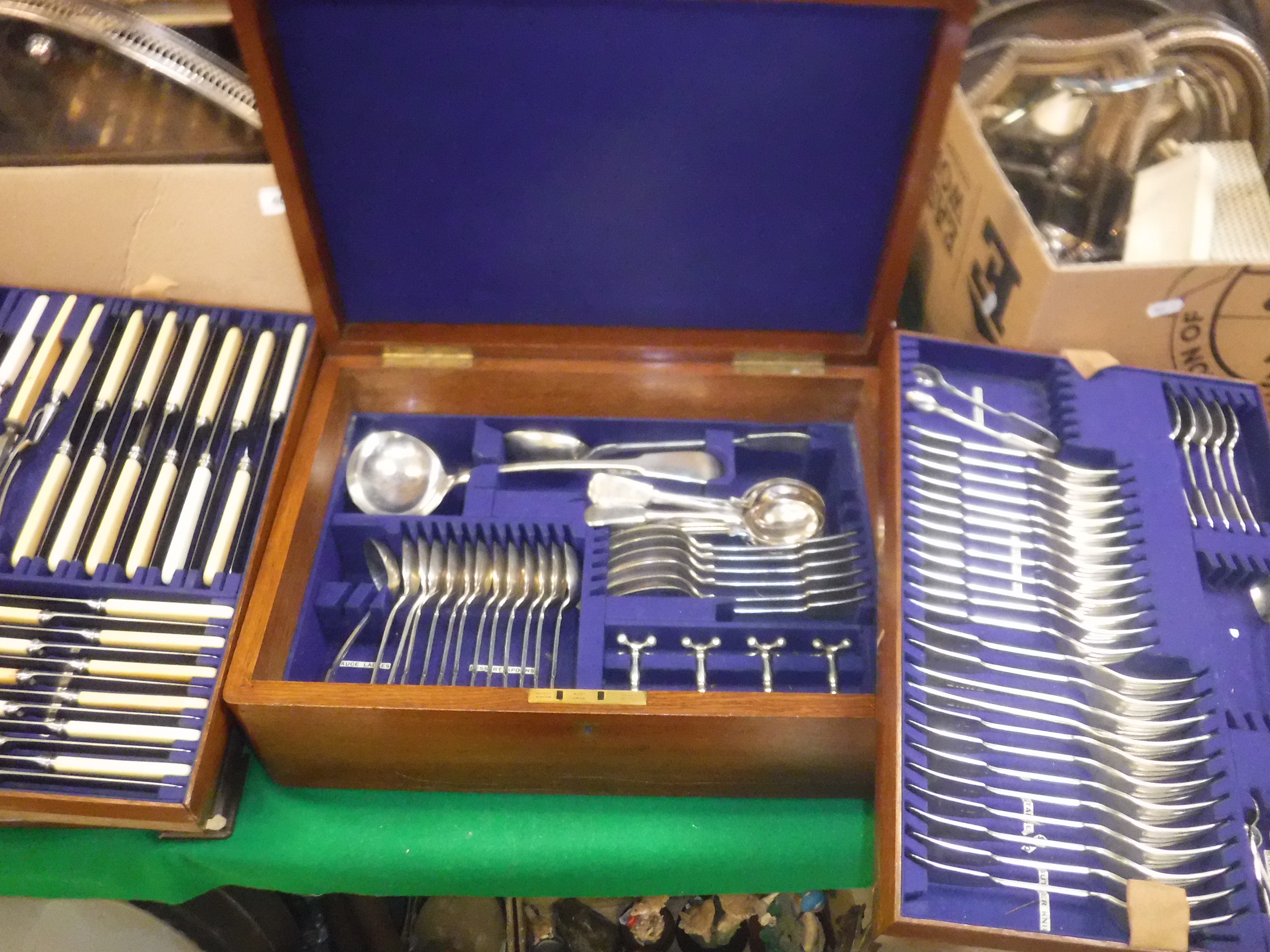 An oak cased canteen containing a set of essentially 12 place settings, plated cutlery, "Fiddle"