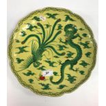 An early 20th Century Japanese Fukagawa famille verte / jaune plate, the main field decorated with a