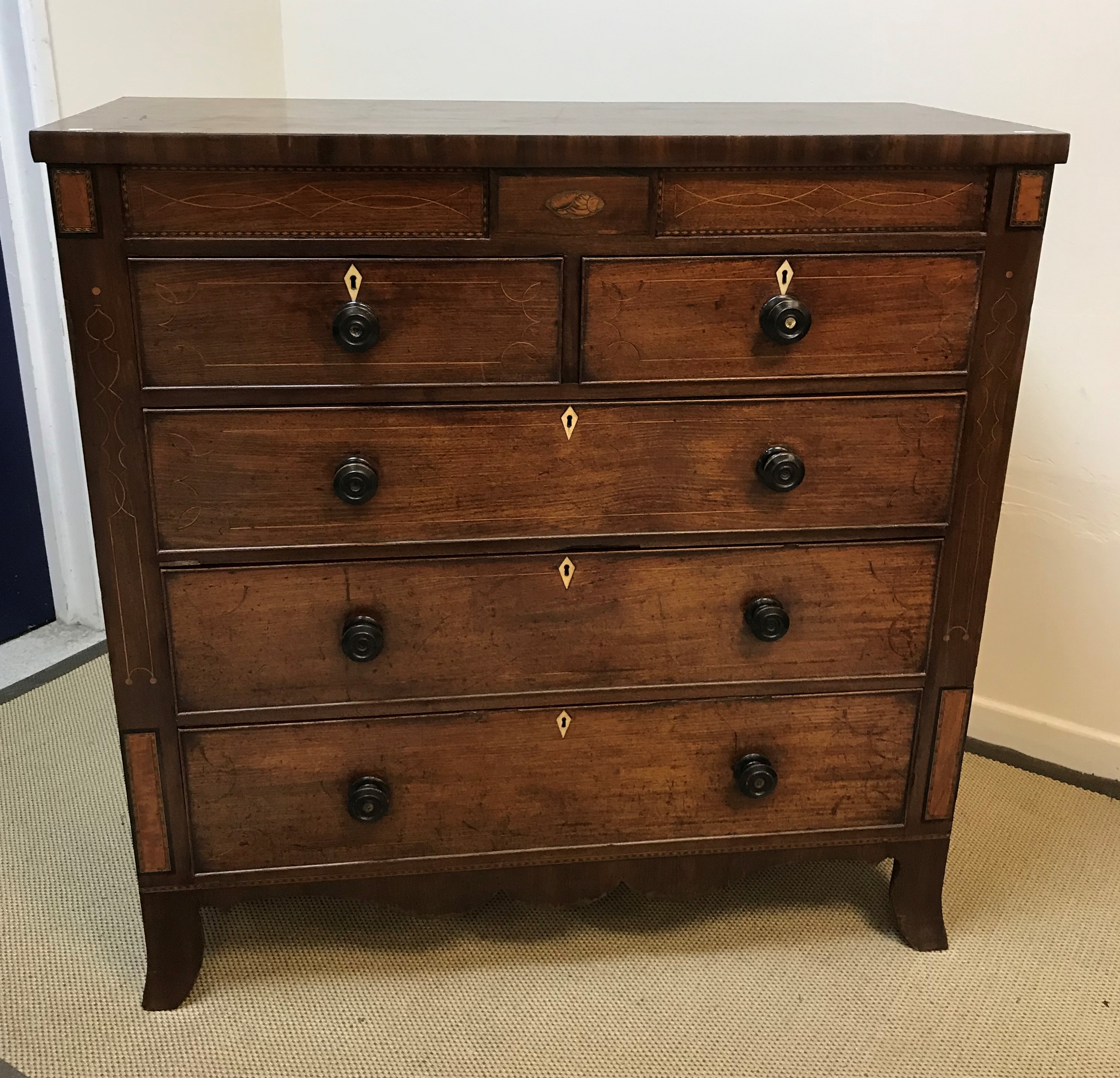 A 19th Century mahogany chest, the plain top above two secret drawers flanking a shell marquetry