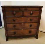A 19th Century mahogany chest, the plain top above two secret drawers flanking a shell marquetry