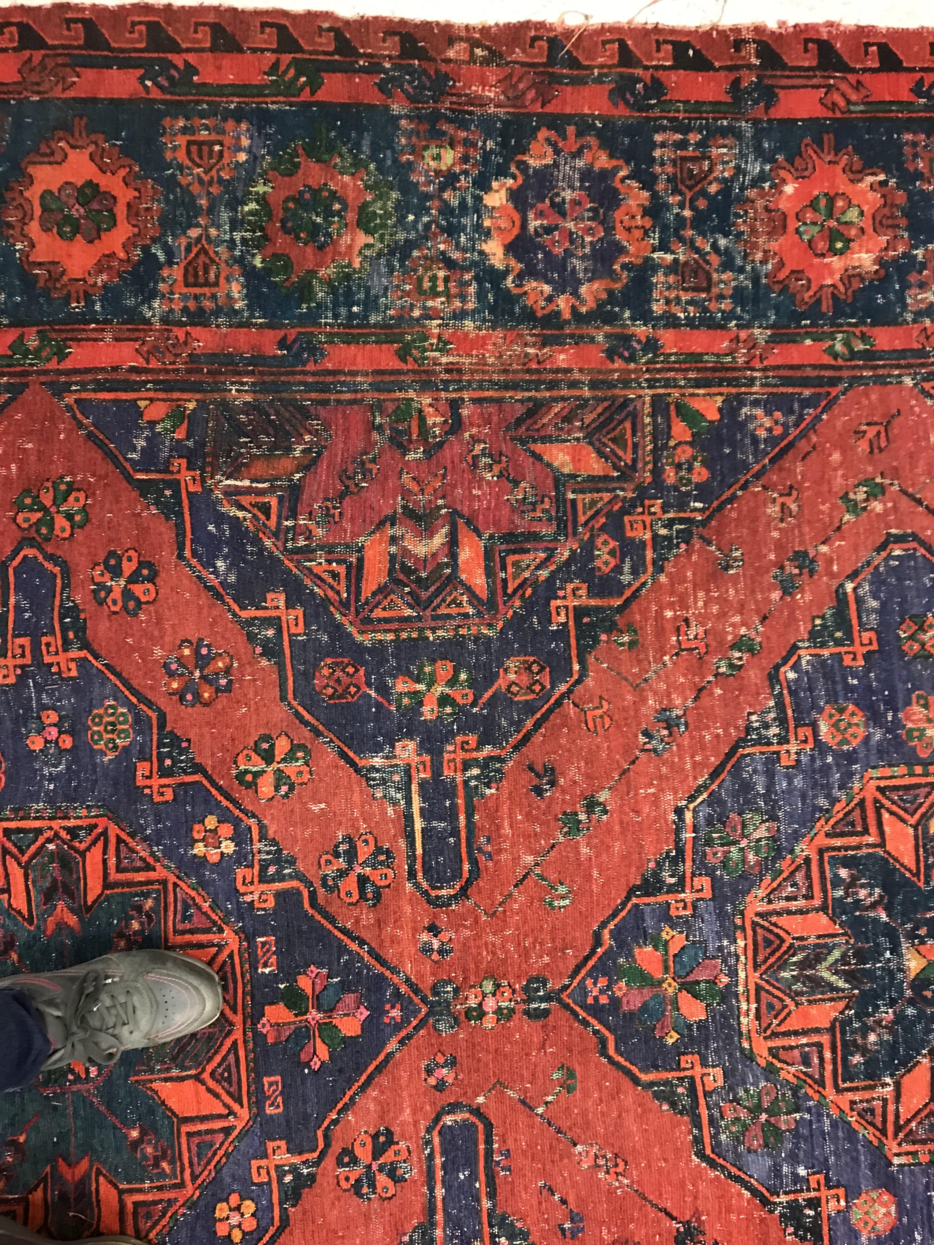 A Persian rug with three repeating lozenge medallions on a red and blue ground, within a blue, red - Image 7 of 20