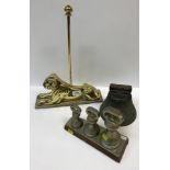 A graduated set of three plated brass bell weights (4 lb, 2 lb and 1 lb) on stand, a brass "lion"
