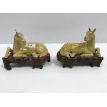 A pair of 19th Century Chinese famille jaune figures of recumbent horses, 15.8 cm long x 10.7 cm