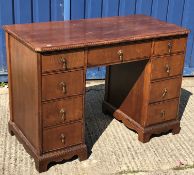 A mahogany kneehole desk in the Georgian style, the top with applied gadrooned edge over three