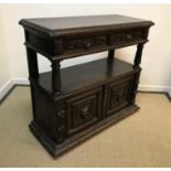 A Victorian carved oak buffet in the Gothic Revival taste, the plain top with lunette carved