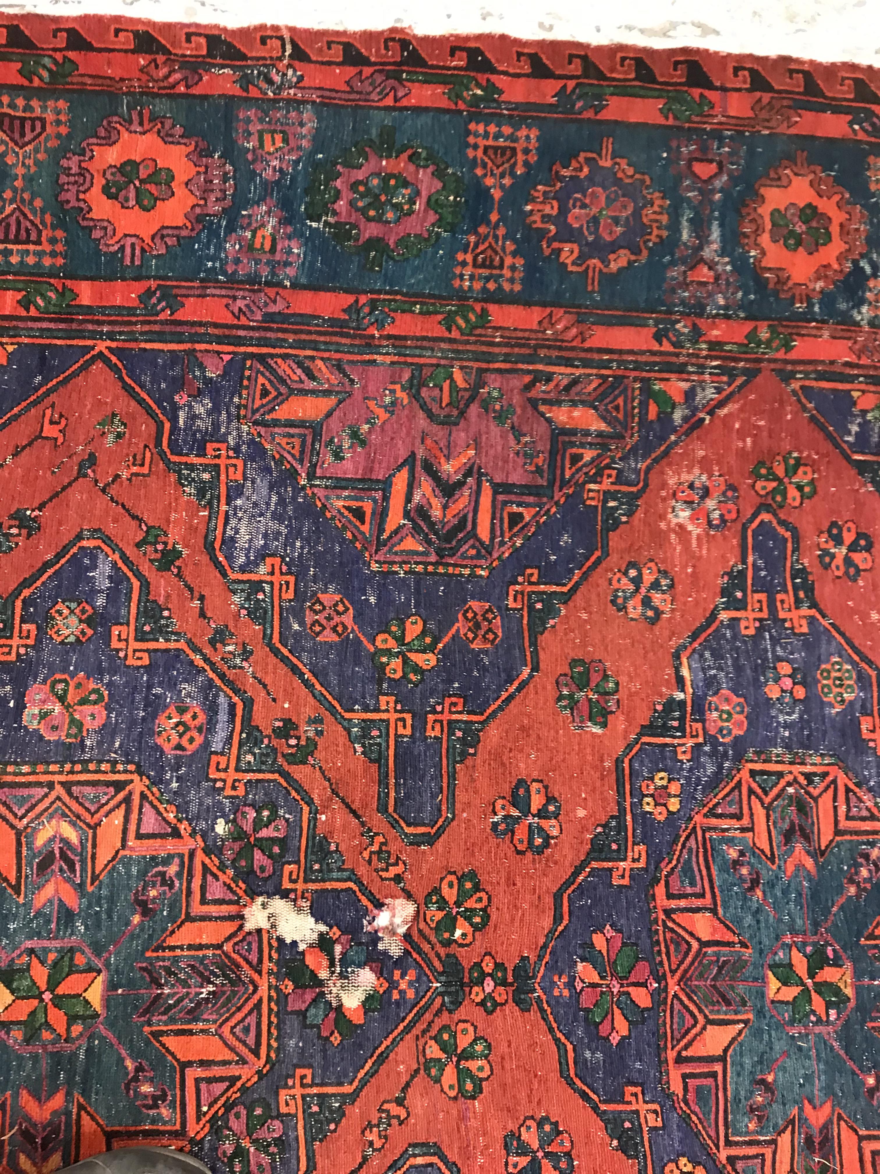 A Persian rug with three repeating lozenge medallions on a red and blue ground, within a blue, red - Image 4 of 20