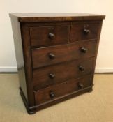 A Victorian mahogany chest of two short over three long drawers with turned knob handles, raised
