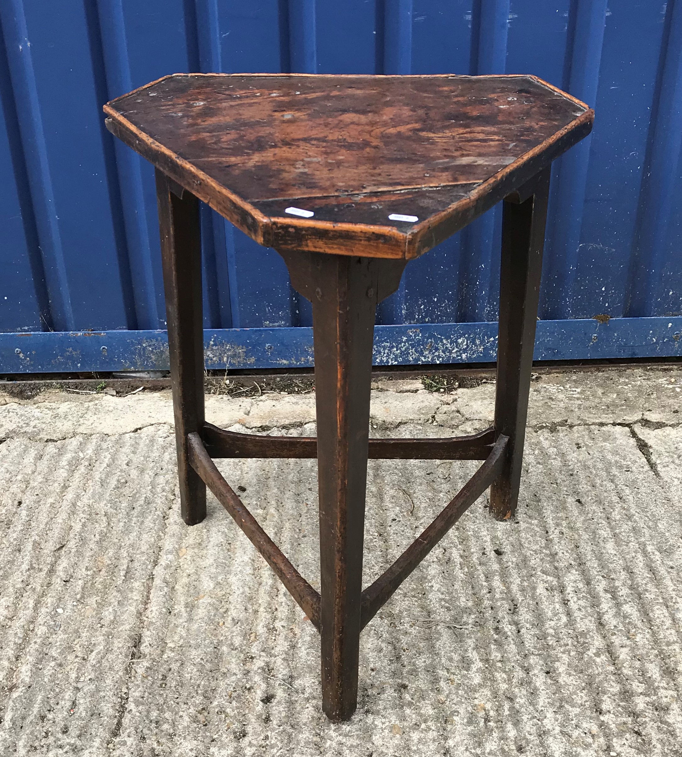 A 19th Century elm and oak cricket table, the triangular top with canted corners and applied beading
