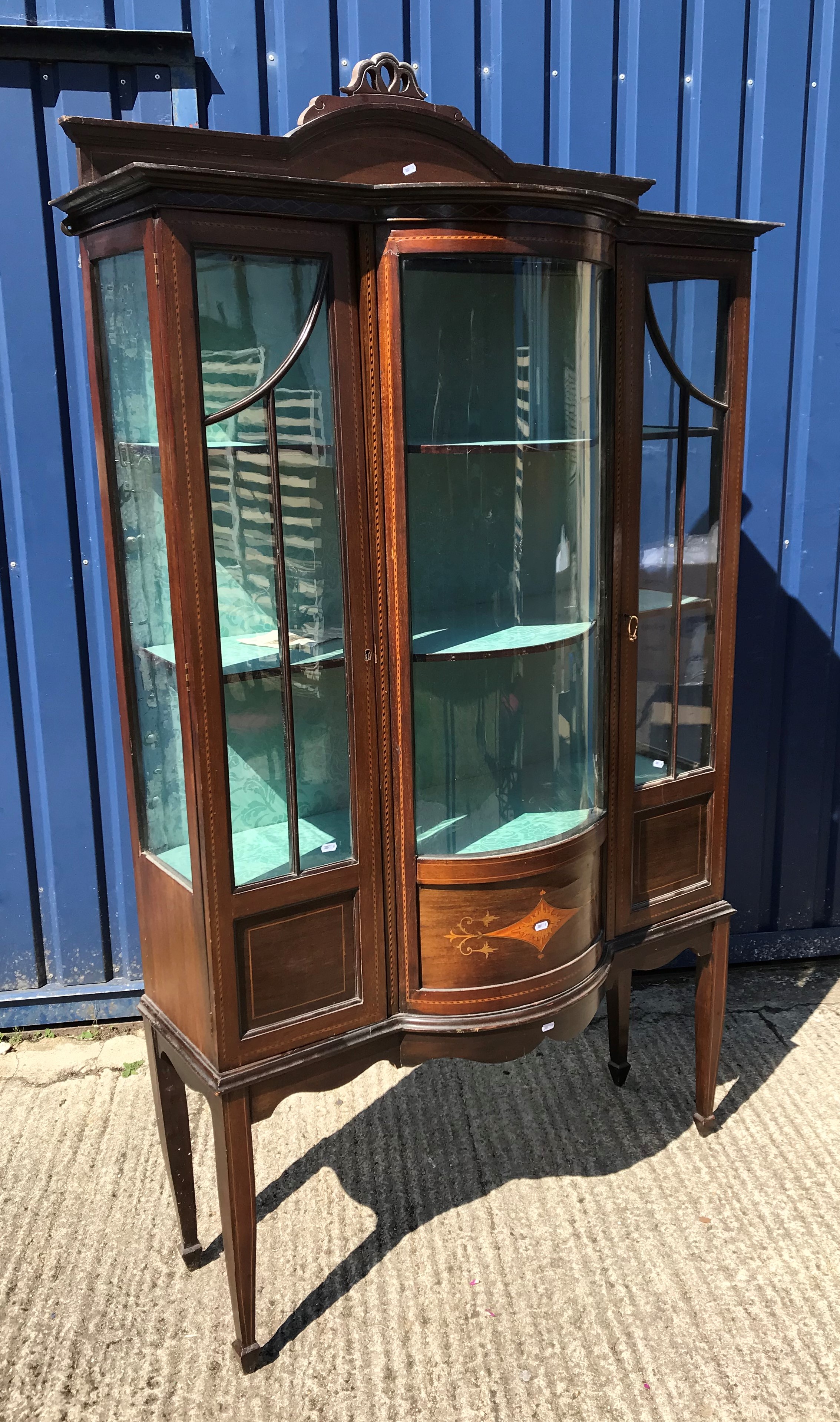 An Edwardian mahogany and inlaid display cabinet with barber pole stringing throughout, the