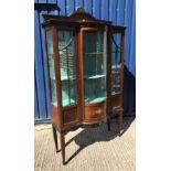 An Edwardian mahogany and inlaid display cabinet with barber pole stringing throughout, the