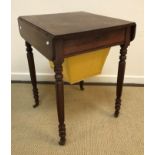 A 19th Century mahogany work table, the rounded rectangular top with two drop leaves over a drawer