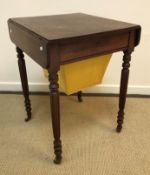 A 19th Century mahogany work table, the rounded rectangular top with two drop leaves over a drawer