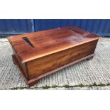 A modern teak living room chest with rising lid over a bank of twelve small drawers raised on