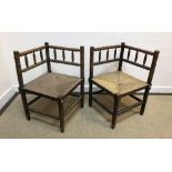 A pair of 19th Century stained beech framed bobbin turned corner chairs with rush seats, 43 cm x
