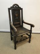 A 19th Century walnut framed hall chair in the Carolean taste, the shell and scroll work carved back