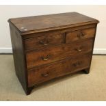 A 19th Century elm chest, the plain top with applied moulded edge over two short and two long
