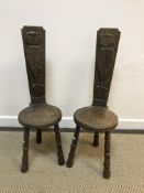 A pair of 20th Century oak spinning chairs, the backs carved with figures of owls upon a post,