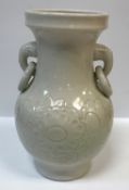 A Chinese cream glazed pottery vase with relief floral decoration to the baluster body and
