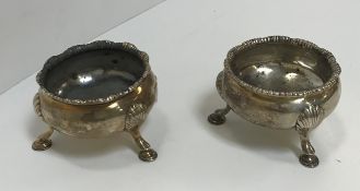 A pair of George II silver open salts of cauldron form with gadrooned rim, raised on shell and