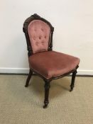 A set of six Victorian mahogany framed dining chairs with buttoned backs over plain upholstered