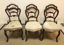 A set of five Victorian walnut standard salon chairs with upholstered seats on moulded cabriole