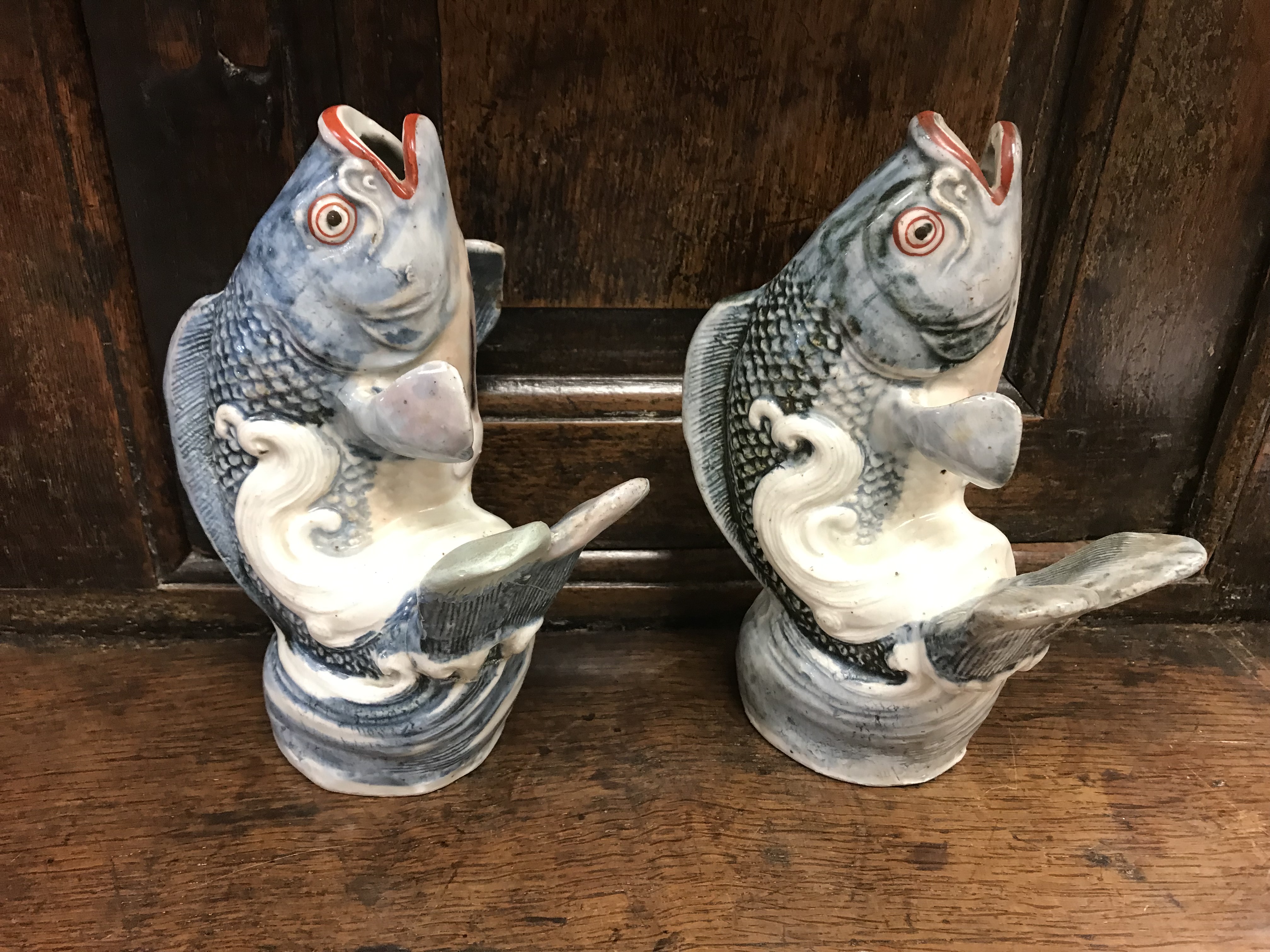 A pair of 18th Century Japanese Arita blue and white and oxide red over-glazed decorated carp