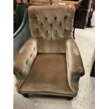 A Victorian buttoned upholstered scroll arm chair on turned front legs to castors