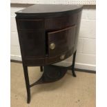 A late George III mahogany corner washstand, the top rising to provide a two section splashback