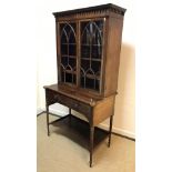 A 19th Century mahogany and inlaid secretaire bookcase, the upper section with decorative cornice