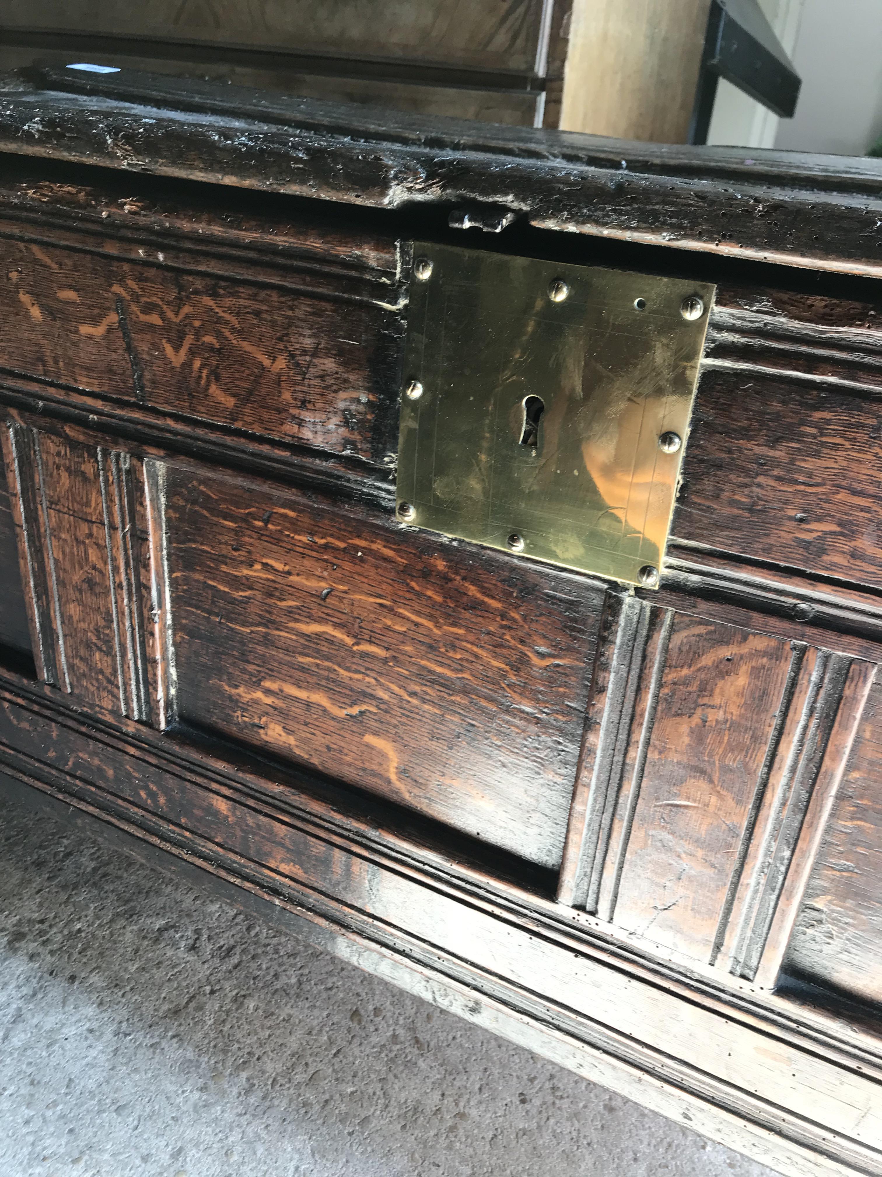 An 18th Century oak coffer, the single piece carved plank top over a three panel front with - Image 7 of 24