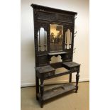 A late Victorian carved oak hall stand in the Gothic Revival taste, the mirrored back with small