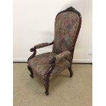 A Victorian mahogany framed high back salon elbow chair with foliate carved top rail and scroll arms