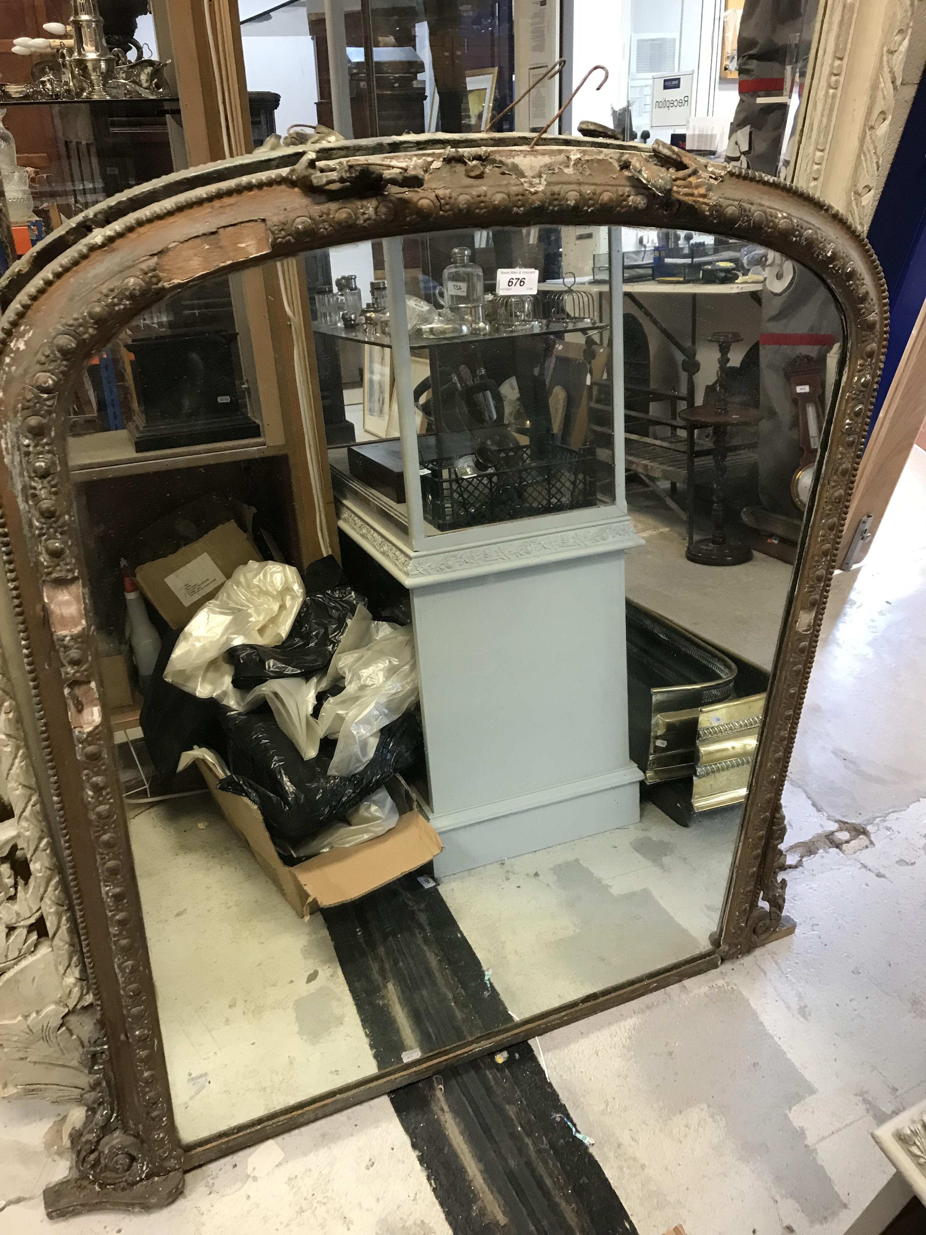 A Victorian gilt and gesso framed dome top overmantel mirror, 95 cm wide x 116.5 cm high