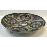 An Iznic type circular charger in blue and yellow with stylised floral design