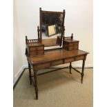 A Victorian walnut dressing table by Gillow & Co, the mirrored superstructure on two banks of