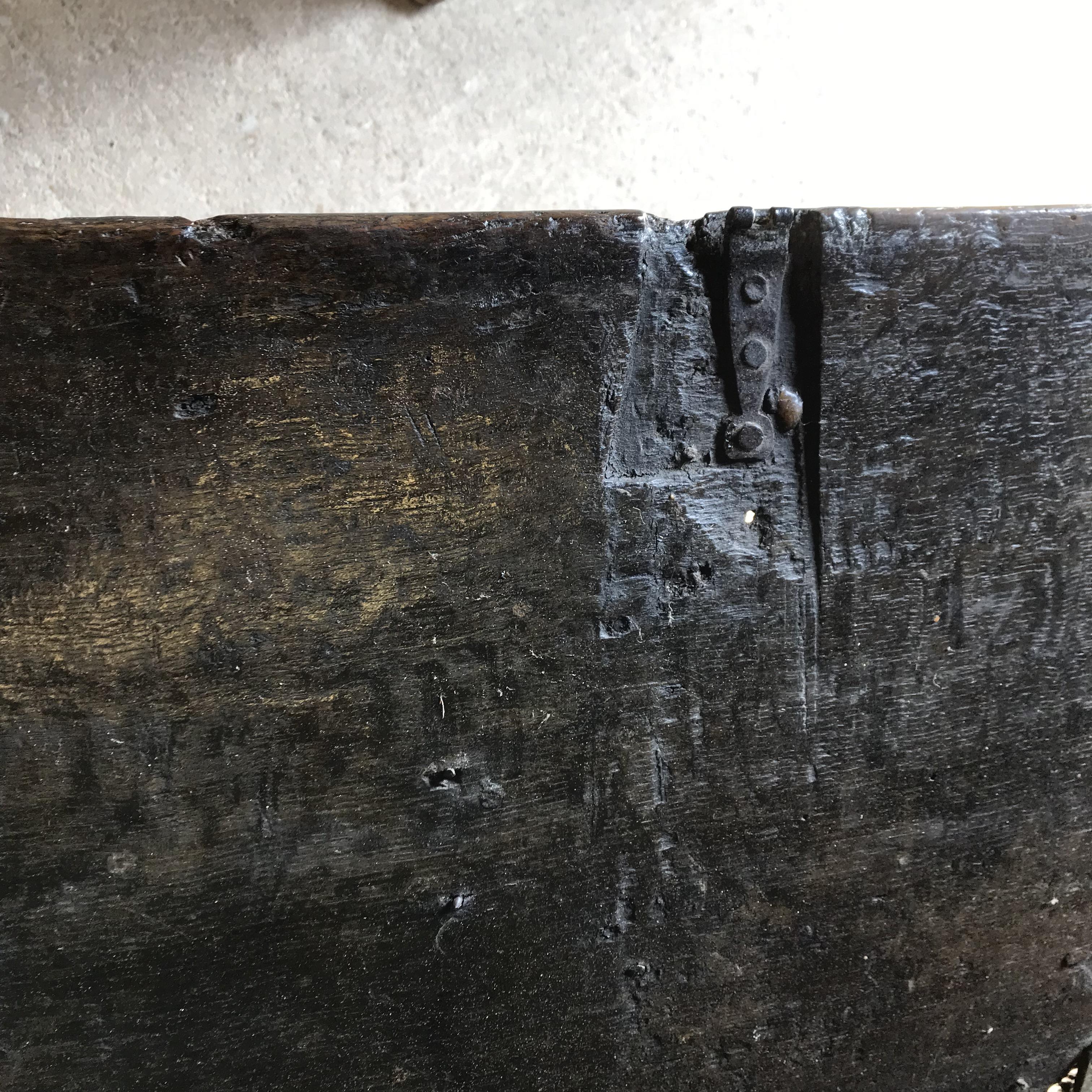 An 18th Century oak coffer, the single piece carved plank top over a three panel front with - Image 14 of 24