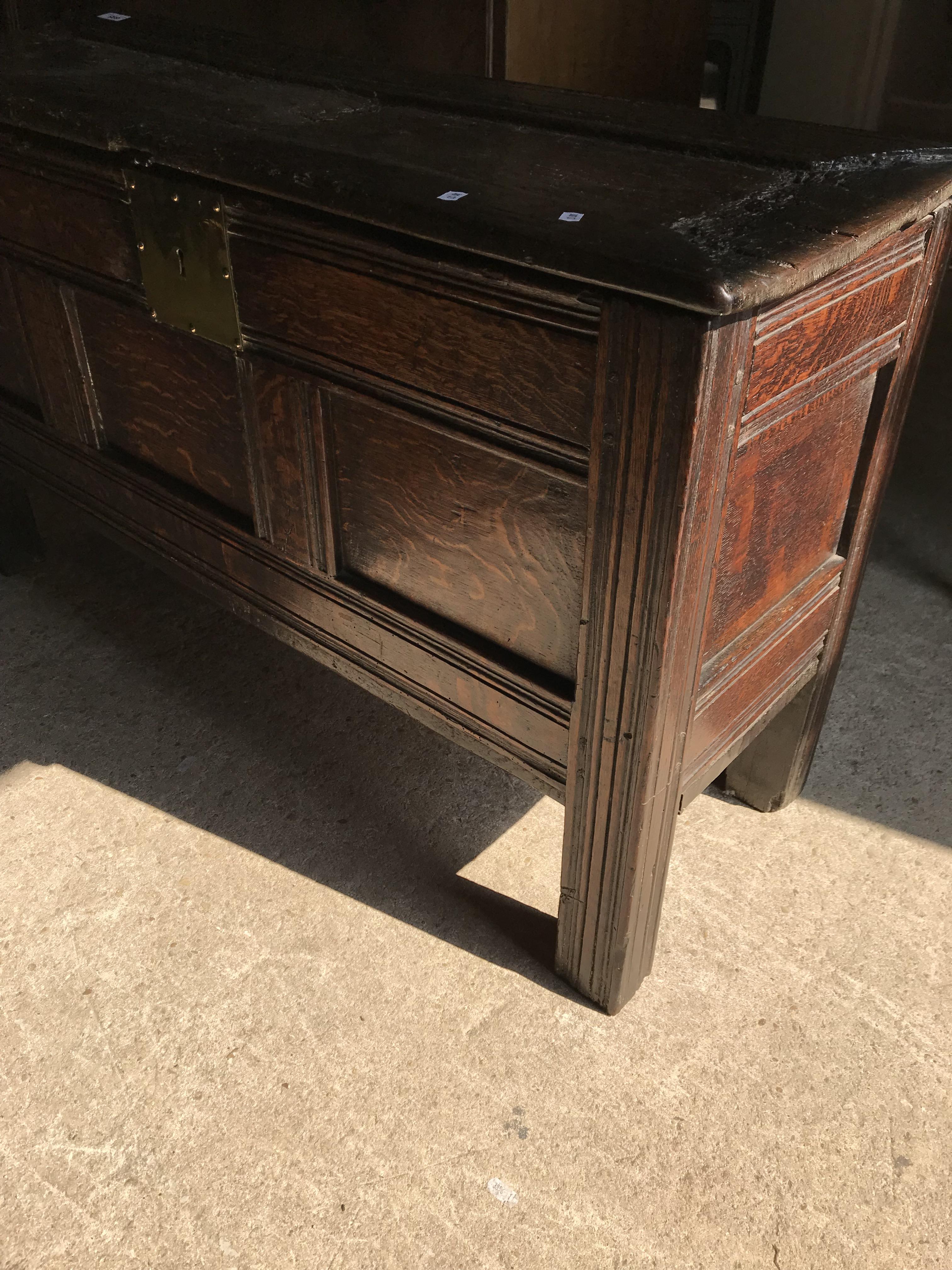 An 18th Century oak coffer, the single piece carved plank top over a three panel front with - Image 8 of 24