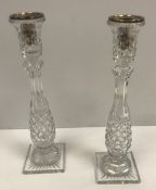 A set of four pineapple cut glass table candlesticks with additional white metal candle holders,