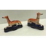 A pair of 19th Century Staffordshire Greyhound inkwells, 15.5 cm long x 11.6 cm high, together
