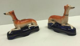 A pair of 19th Century Staffordshire Greyhound inkwells, 15.5 cm long x 11.6 cm high, together