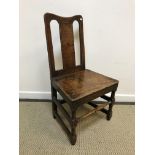 A late 18th / early 19th Century oak panel seated hall chair on turned and block legs united by