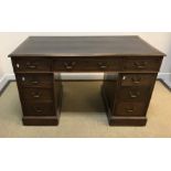 A circa 1900 mahogany double pedestal desk, the top with tooled and gilded leather insert writing