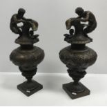 A pair of 19th Century patinated bronze ornamental ewers in the Classical taste, decorated with