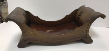 A George III mahogany cheese coaster of "C" scroll form raised on brass and leather casters 48 cm