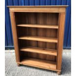 A modern teak open bookcase with three shelves flanked by fluted side columns on turned feet 112.5