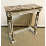 An Empire style pier table, the marble top over a plain frieze with wreath medallion carved ends,