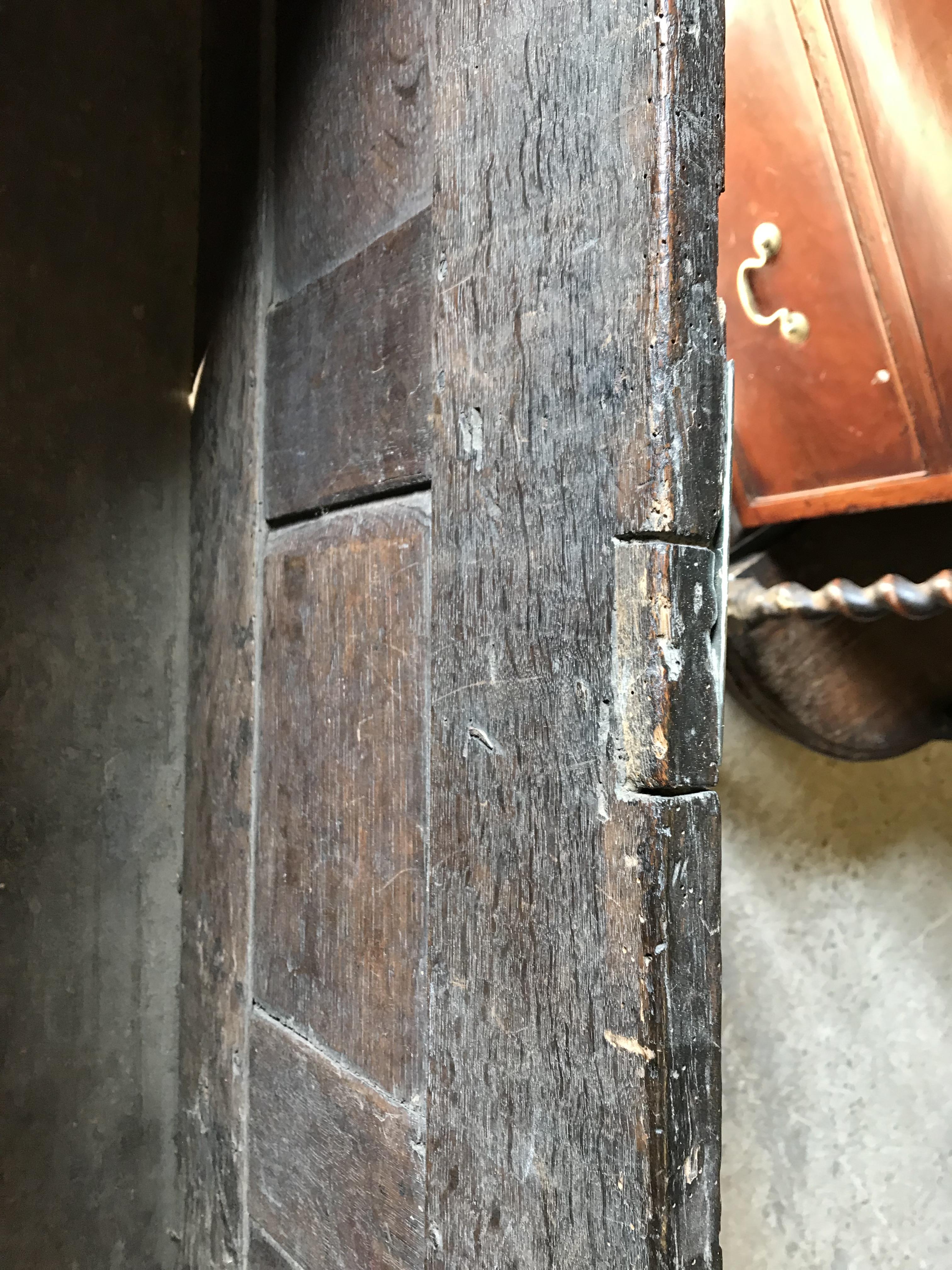 An 18th Century oak coffer, the single piece carved plank top over a three panel front with - Image 20 of 24